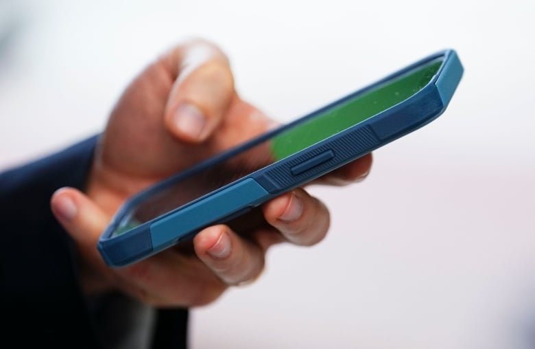 A close-up of a hand holding a smartphone