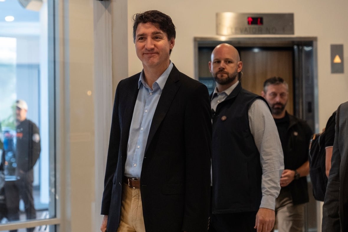 Prime Minister Justin Trudeau walks through the lobby of the Delta Hotel by Marriott, Saturday, Nov. 30, 2024, in West Palm Beach, Fla.