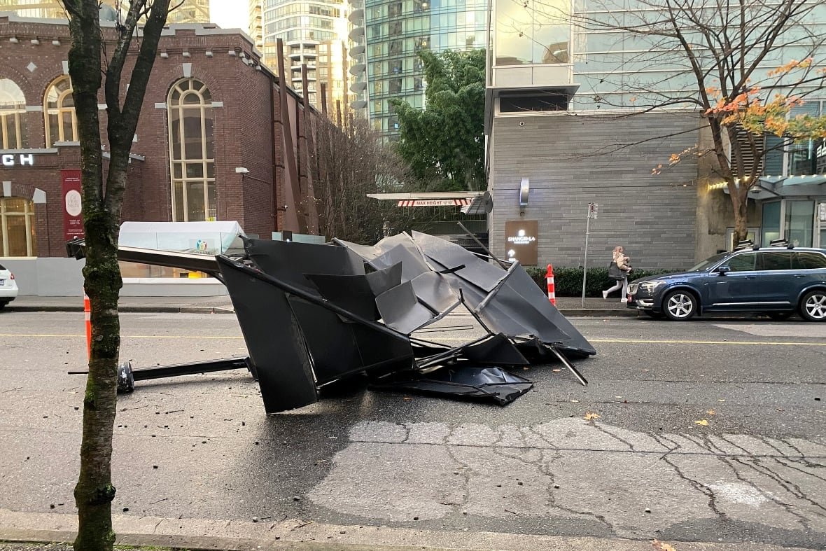 A crushed canopy tent in the middle of a road.