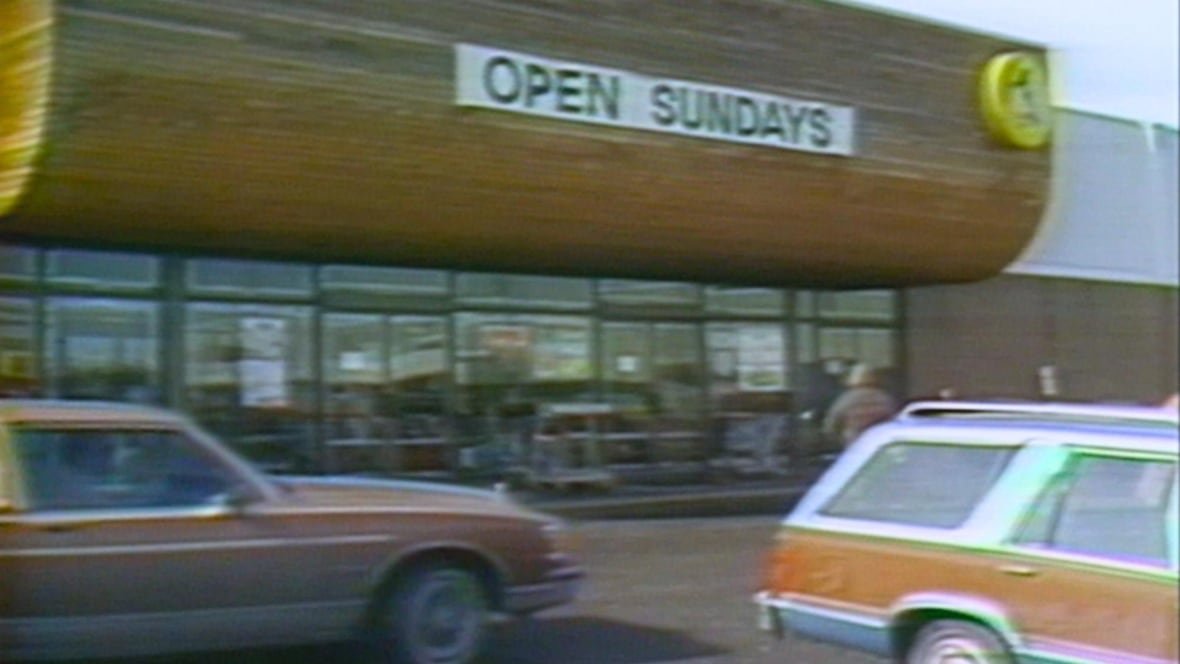 The exterior of a store is pictured that reads "open Sundays."