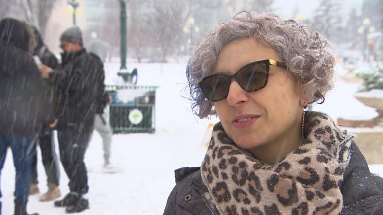 Picture of a woman in blowing snow wearing glasses.