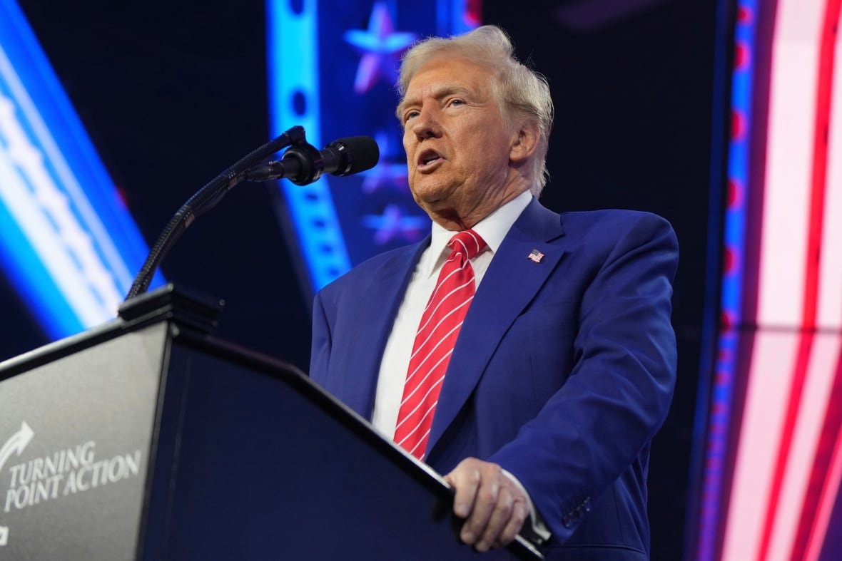 Donald Trump at a podium labelled 'Turning Point Action'