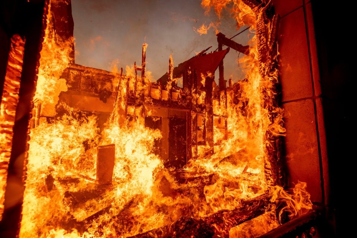 A ferocious fire on a structure is shown in closeup.