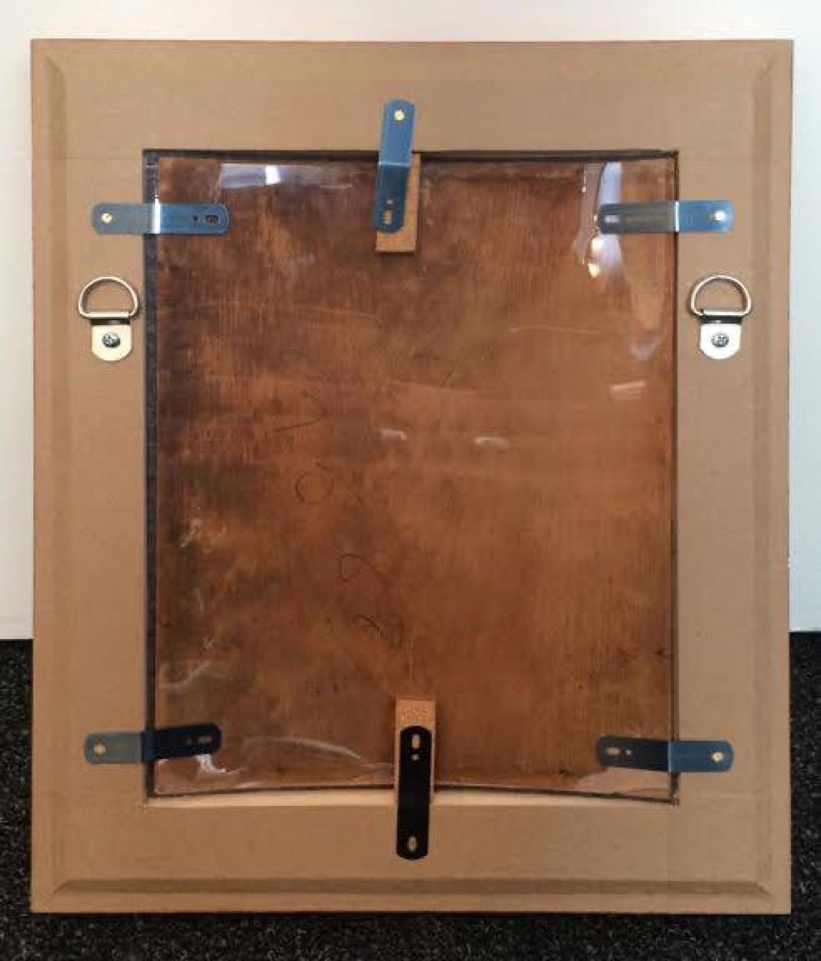 A photograph of the back of the painting in question, which appears to be in a wooden frame.