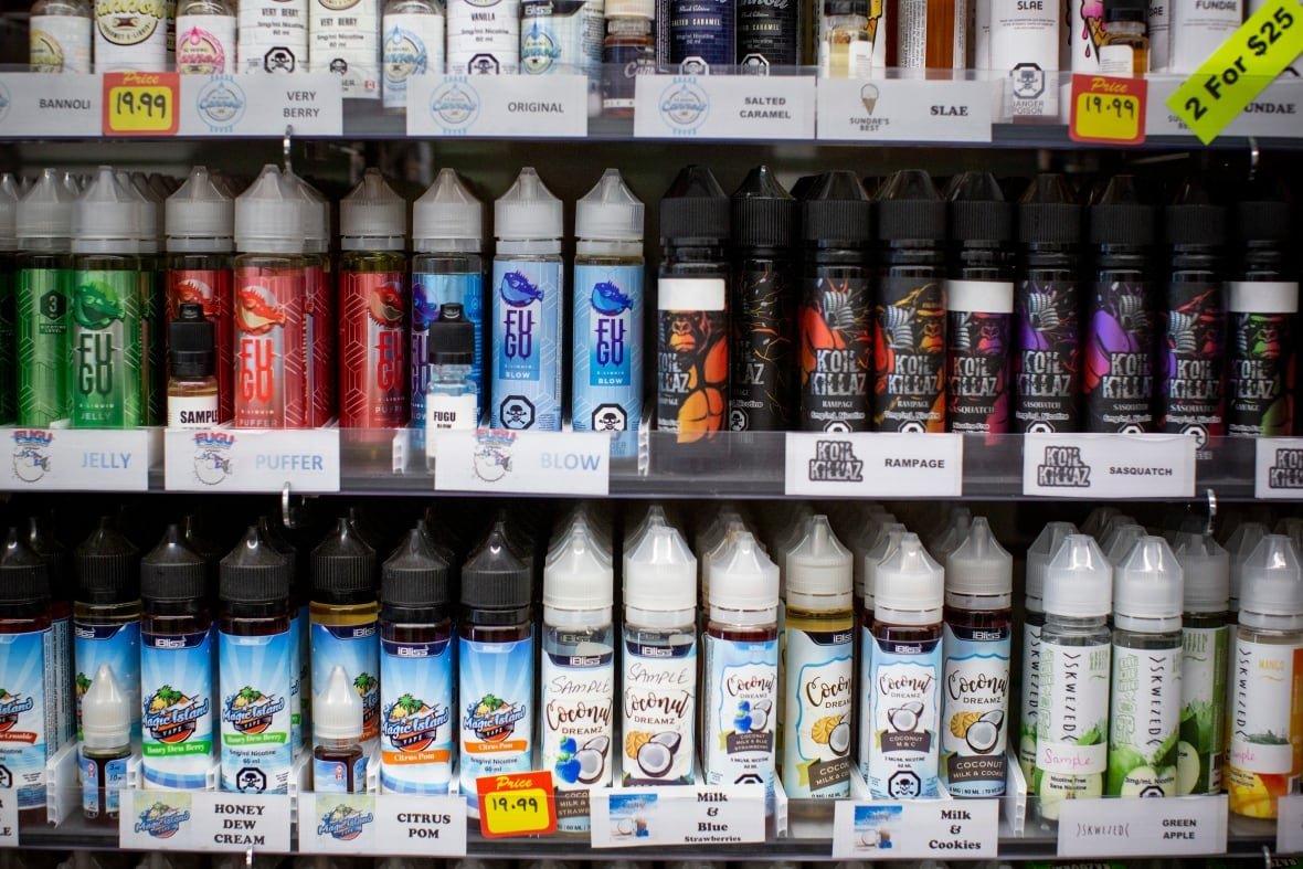 A row of vape juice is seen on a store shelf.
