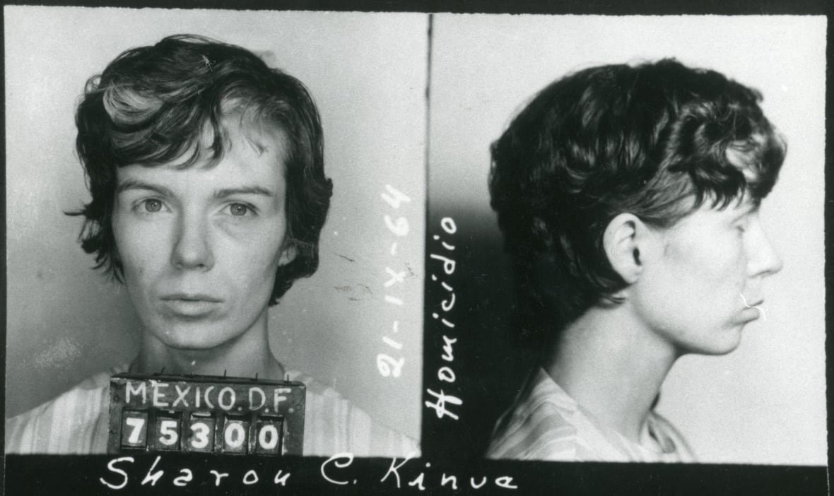 Black and white mugshot photo of a woman