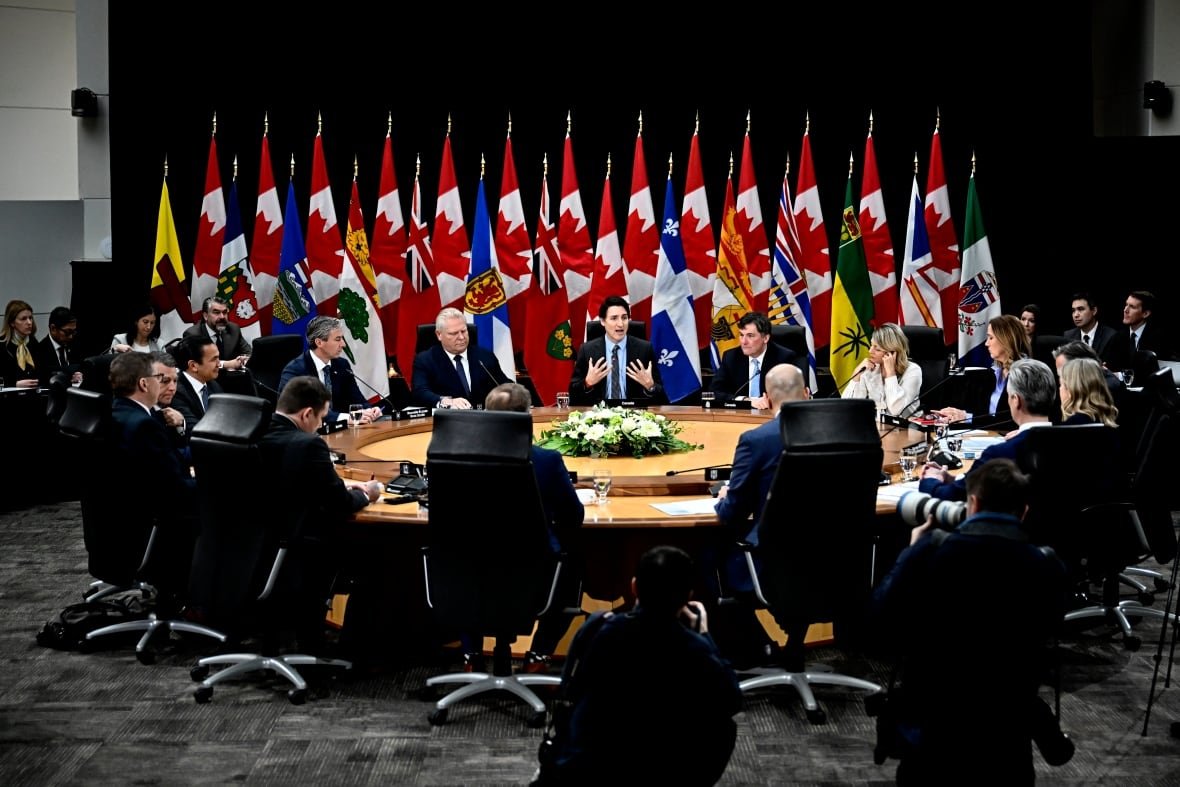 People are seen seated at a roundtable.