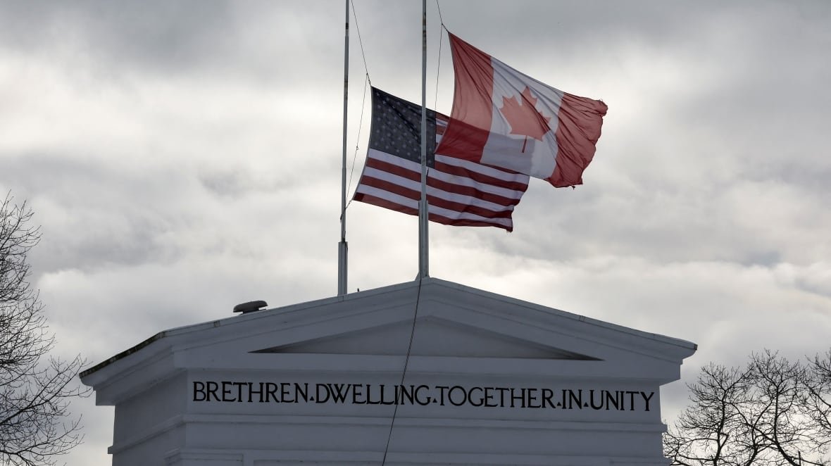 An arch with the Canadian and United States flags with the inscription: Brethren dwelling together in unity