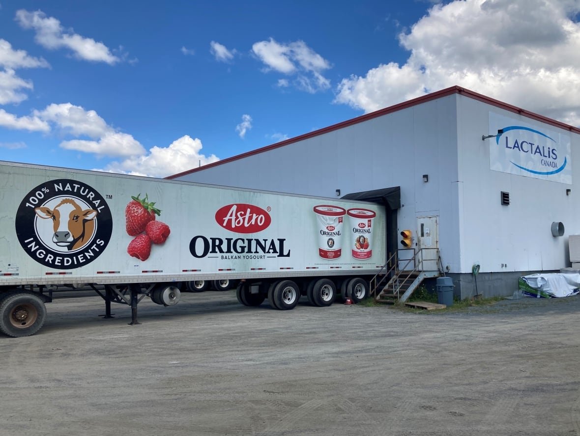 A large warehouse with a trailer attached.