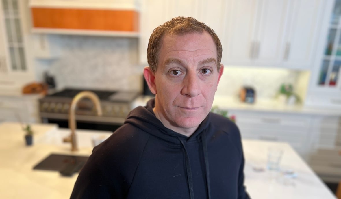 Peter Mikhail standing in his kitchen 