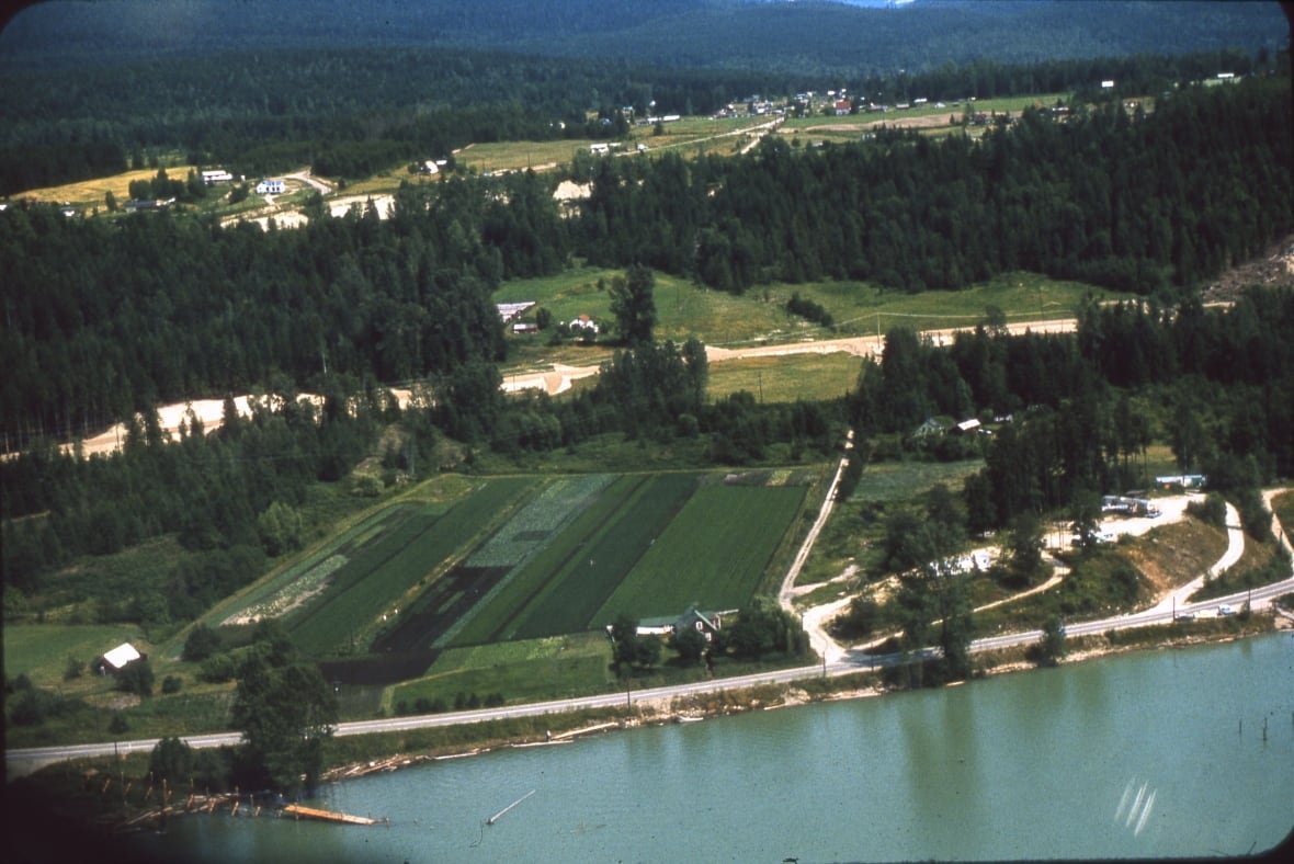 A farm seen from an ariel view near a river.