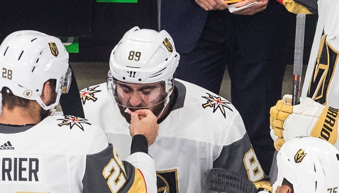 Vegas Golden Knights' William Carrier (28) and Alex Tuch (89) share smelling salts.