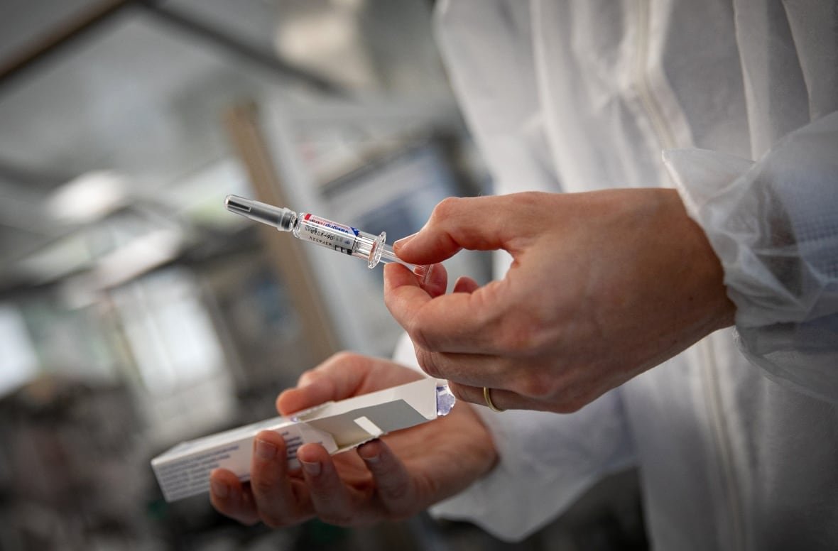 An employee shows a flu vaccine at a French pharmaceutical company Sanofi's laboratory in Val-de-Reuil, north-eastern France, on September 5, 2022.