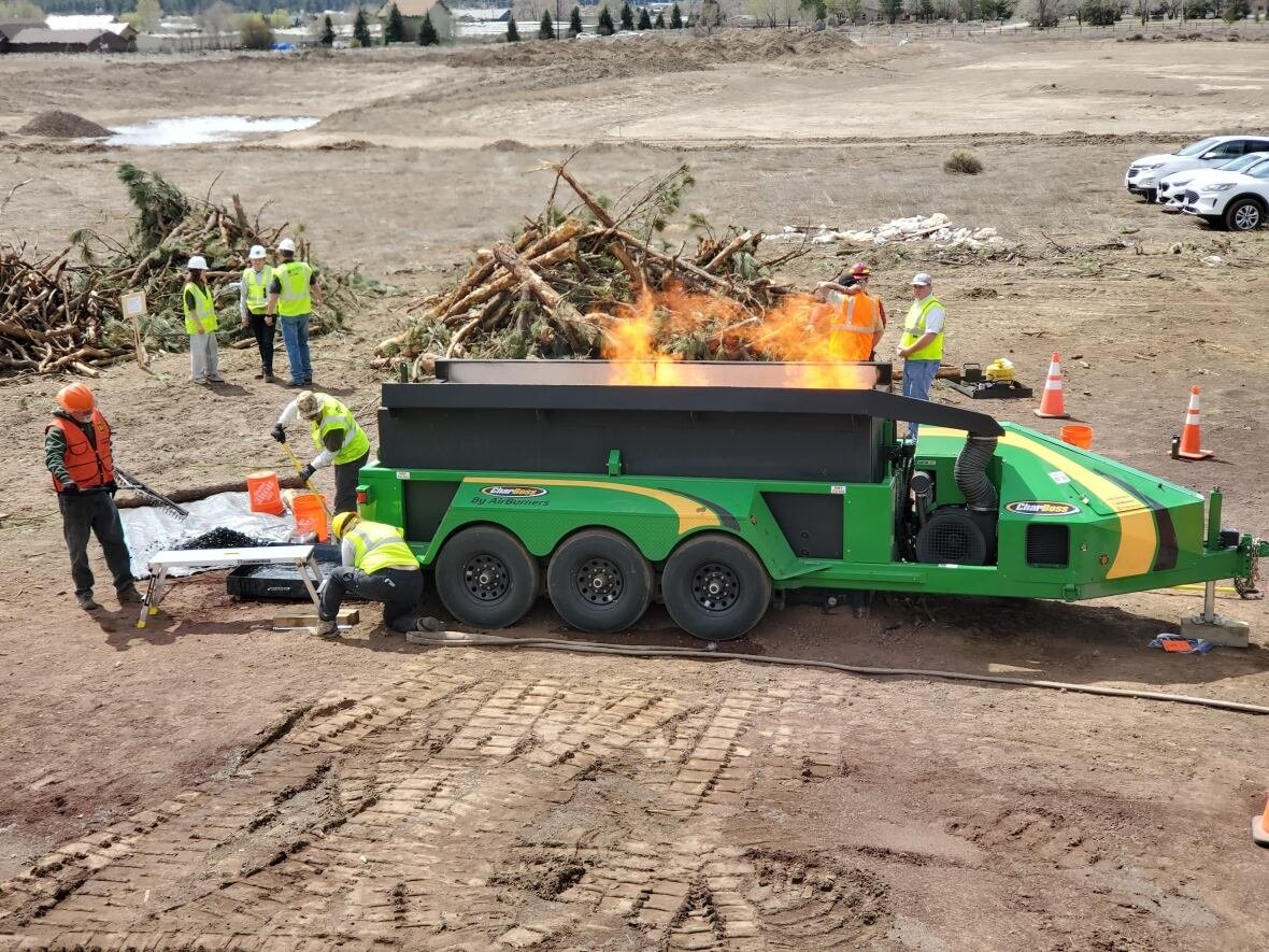 A kiln on wheels with flames coming out the top. 