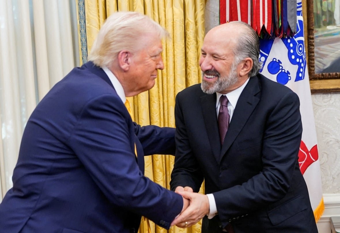 Two people shake hands.