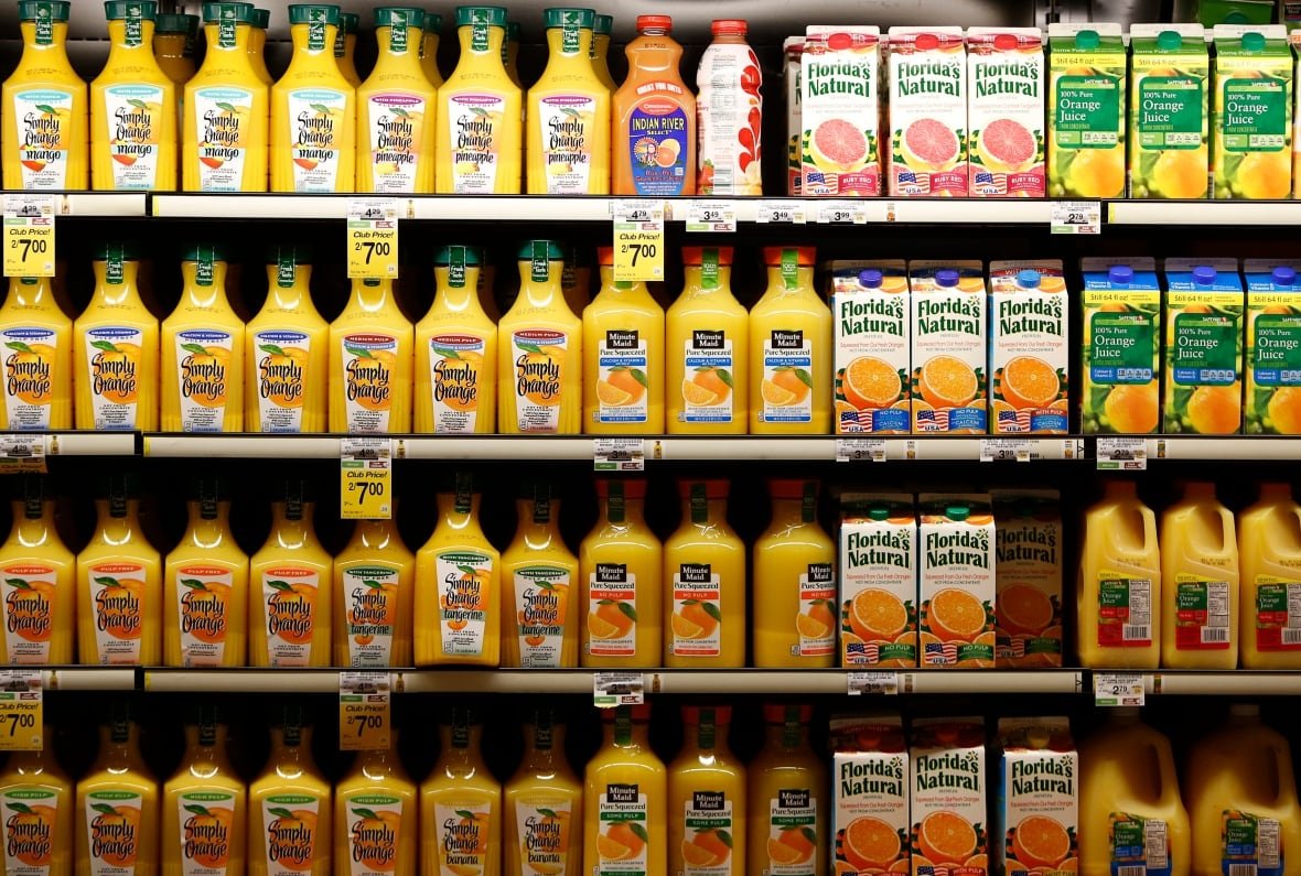 A shelf of orange juice