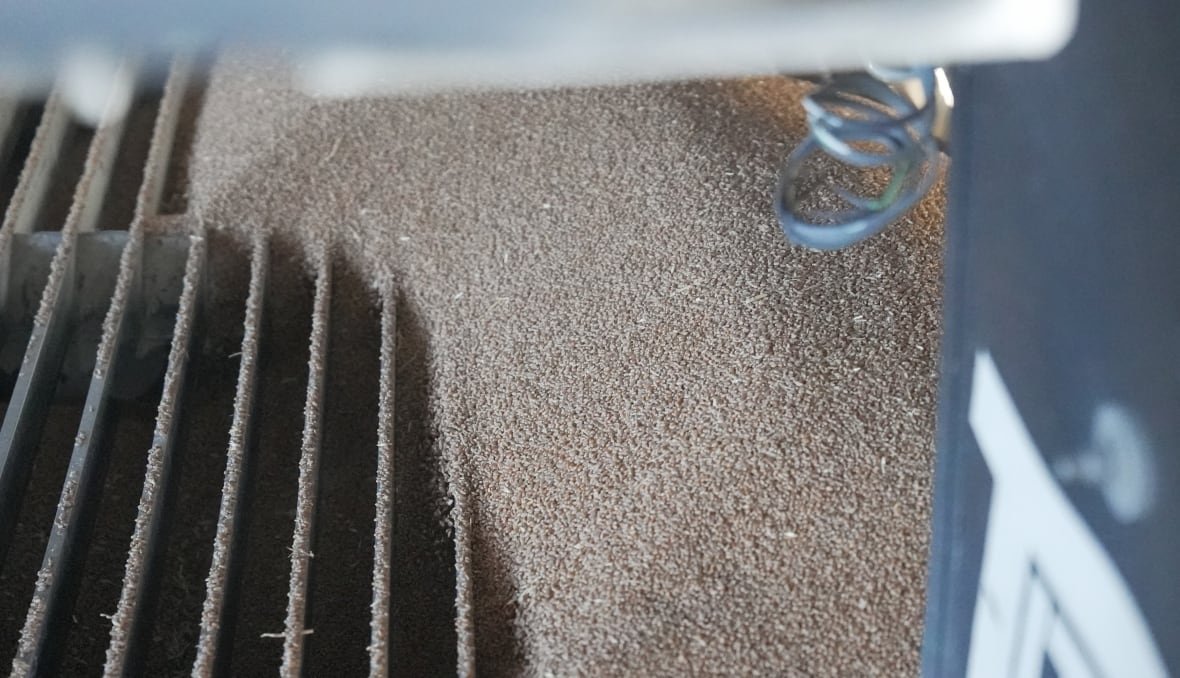 Wheat falls into gratings at a grain elevator