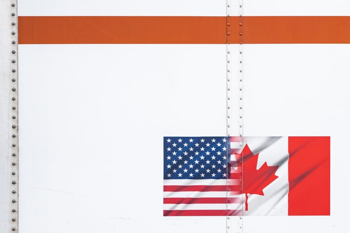 U.S. and Canada flags are seen on a transport truck trailer at the Pacific Highway Canada-U.S. border crossing in Surrey B.C., on Tuesday, March 4, 2025.