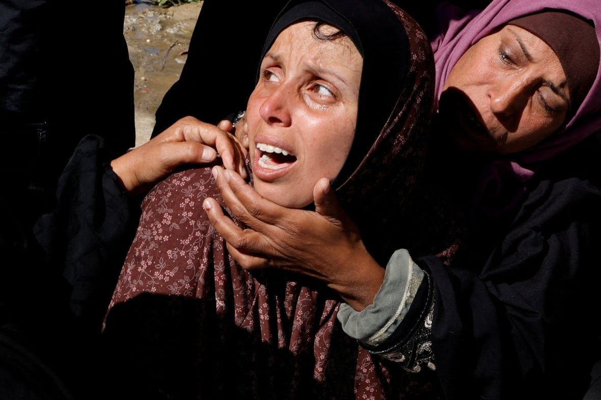 A person embraces another who is mourning.
