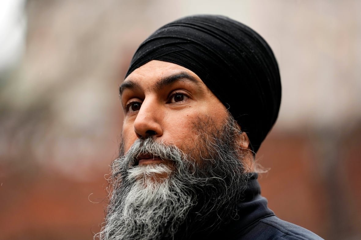 A man looks past a camera.