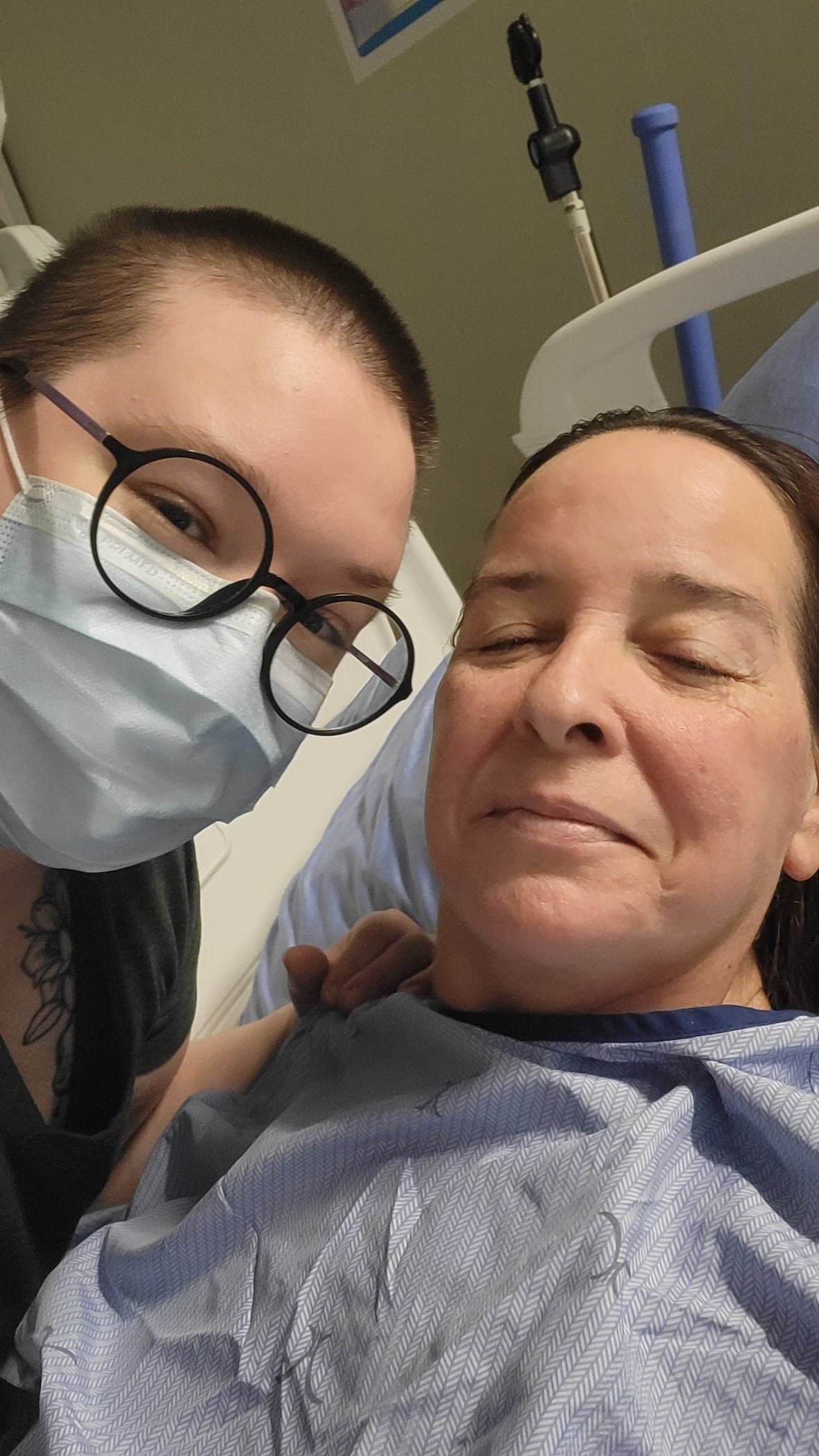 Masked woman takes picture of a masked patient 