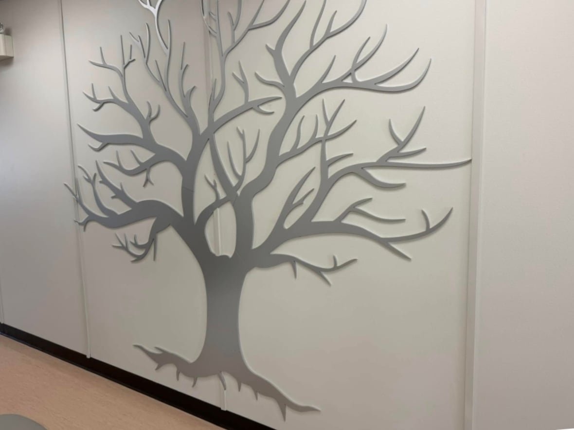 A decal of a tree on the walls of a medical clinic.
