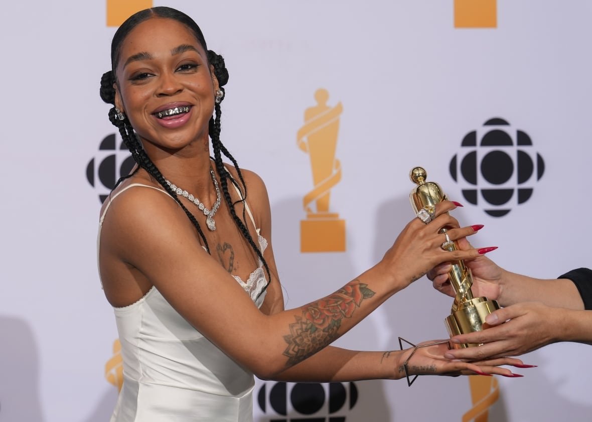 A woman accepts an award. 