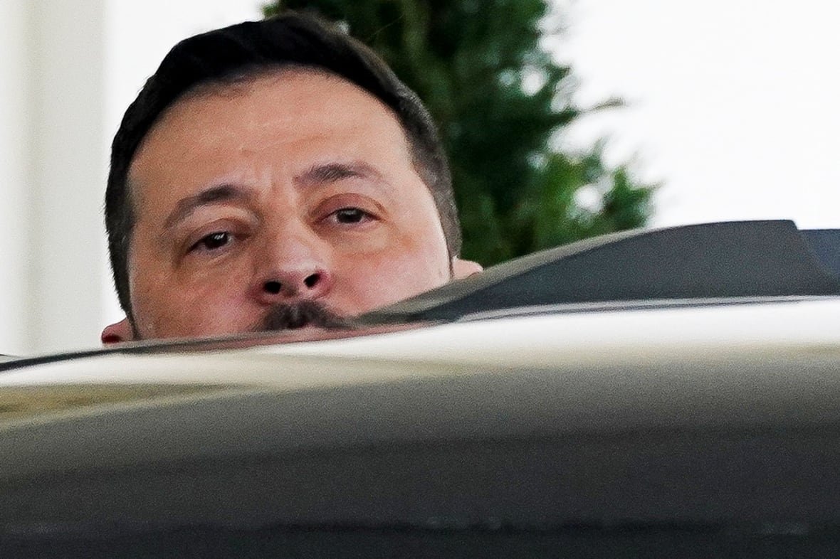 Zelensky, appearing red-eyed, entering a black car