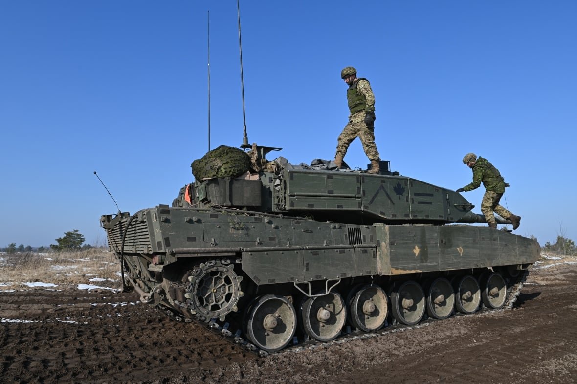 Canadian troops climb on a Leopard 2A4 main battle tank during a recent exercise at the Adazi training range in Latvia. 