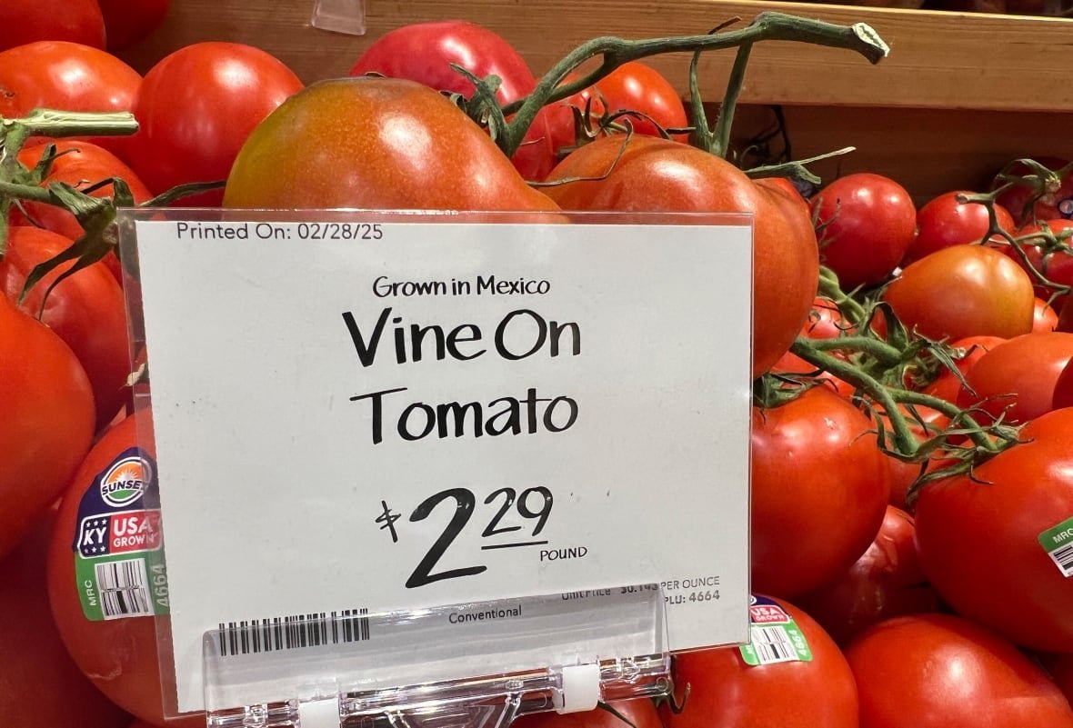 A price tag is seen on a shelf of tomatoes at a grocery store.