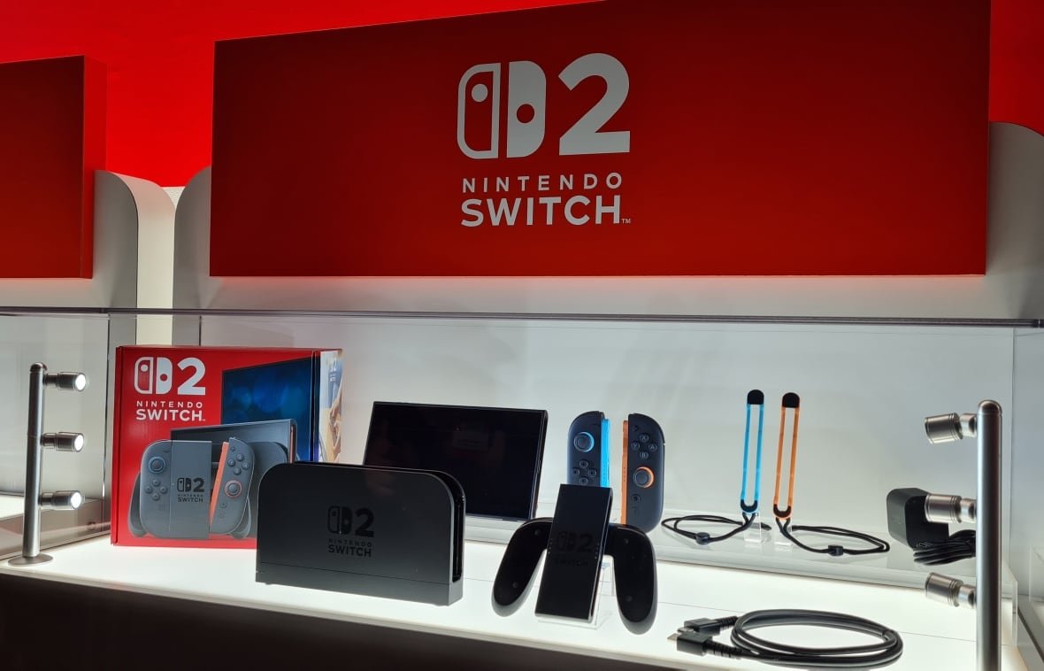 The components of Nintendo's Switch 2 console are displayed on a white counter with red Nintendo branding. 