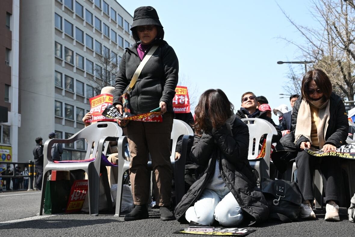 Demonstrators react negatively during a public rally.