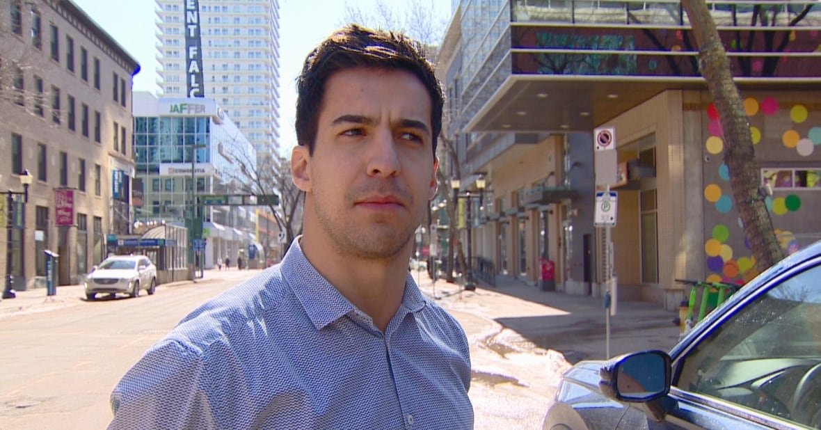 white man in a button up shirt on downtown street