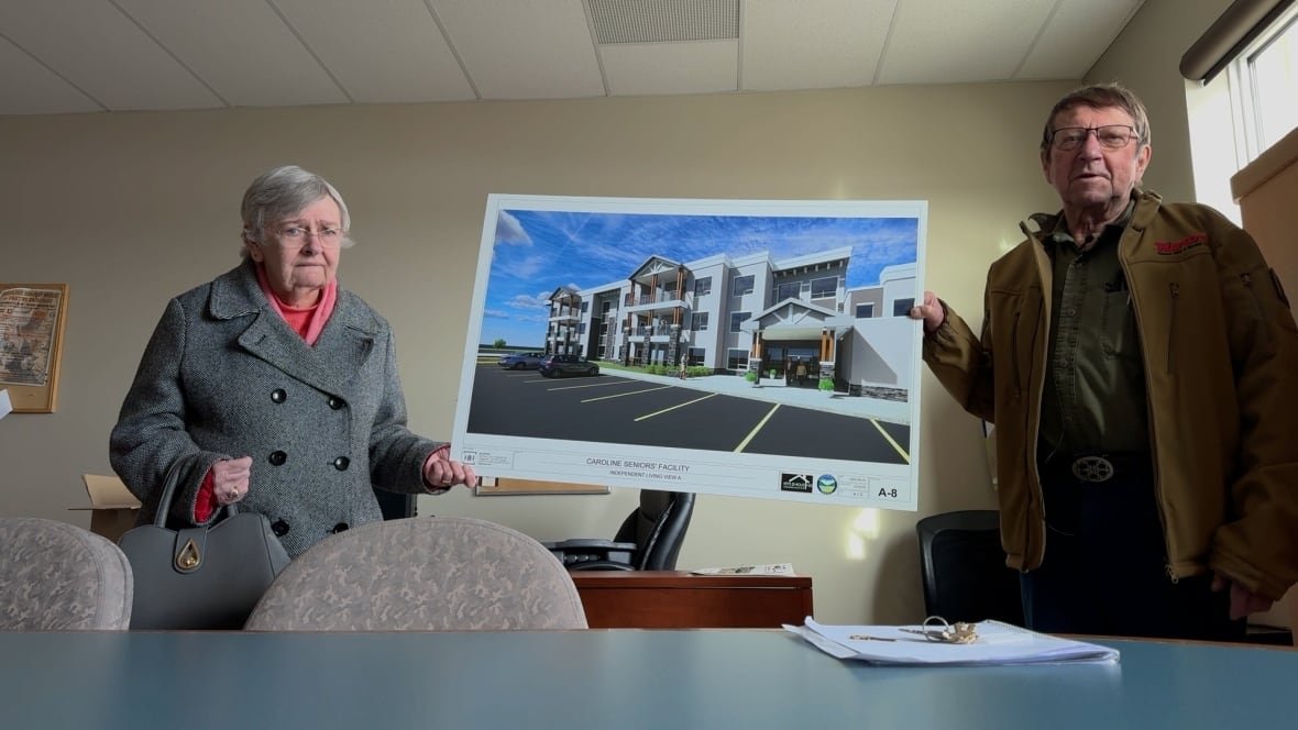 Reg Dean and Barbara Gibson hold a picture of an artist's rendering of a proposed senior's care home. They believe the project has a better chance to proceed now that the community is part of Clearwater County.