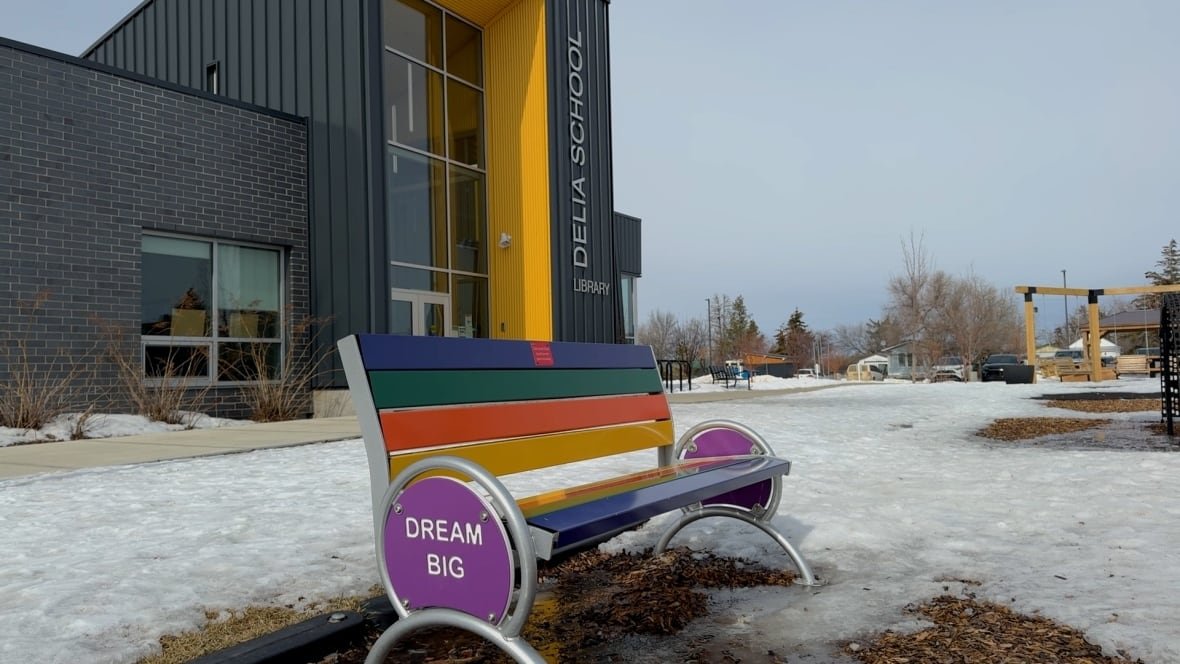 A rainbow-coloured bench sits in front of Delia school in Delia, Alta. 