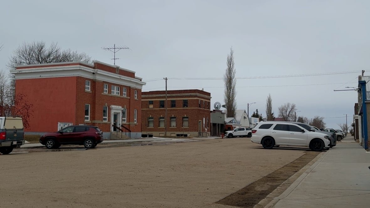 Main Street in Delia, Alta. is shown with a couple of century old, two-storey red brick buildings. 