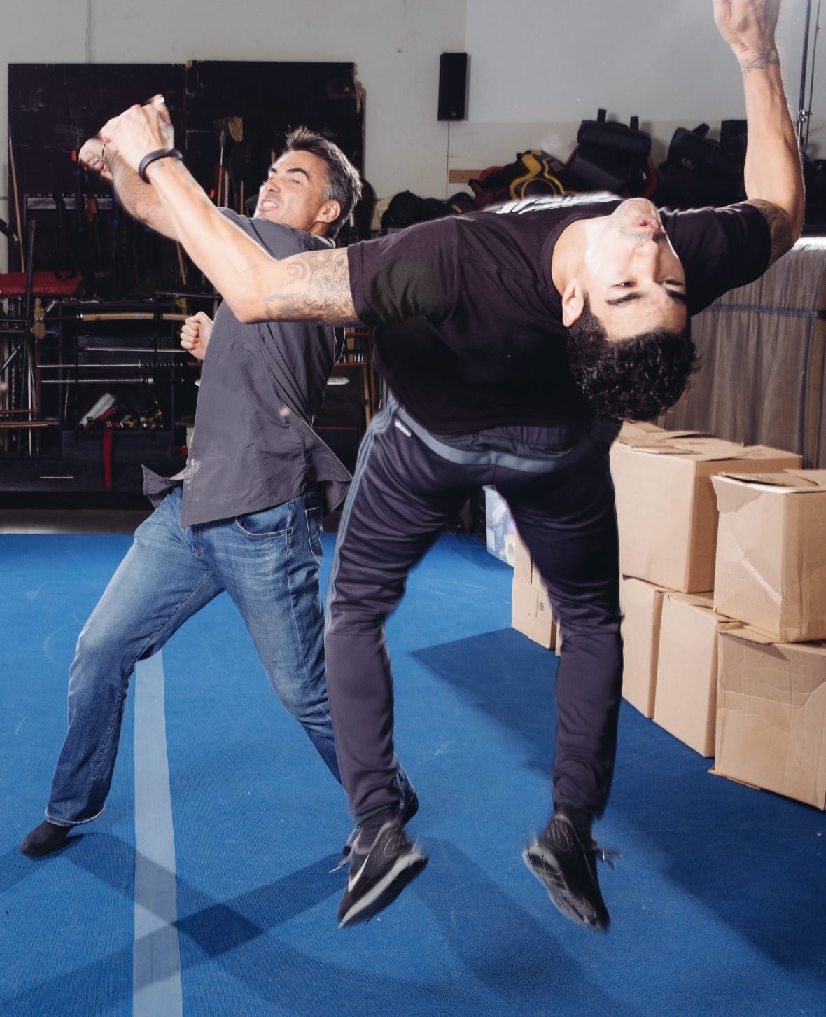 Chad Stahelski, left, demonstrates a movie stunt performer-delivered uppercut at a California studio in October 2014.