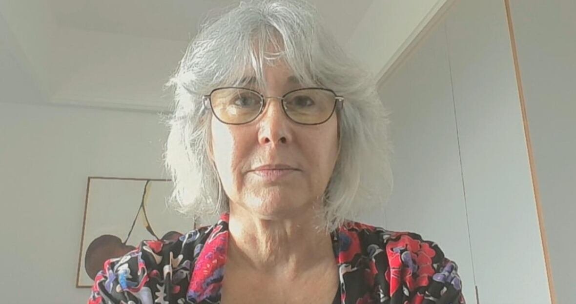 Woman on web cam staring at camera, not smiling.