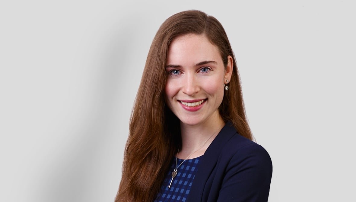 Woman in a blazer smiling.