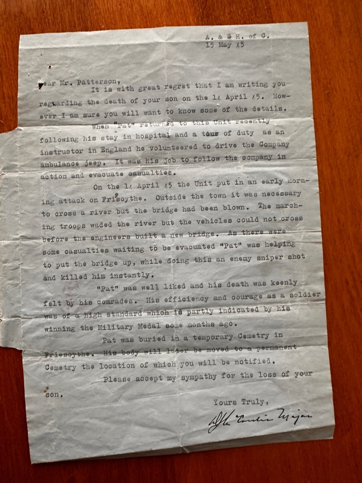 A faded blue letter written by an official informing the family of Welby Patterson's death. 