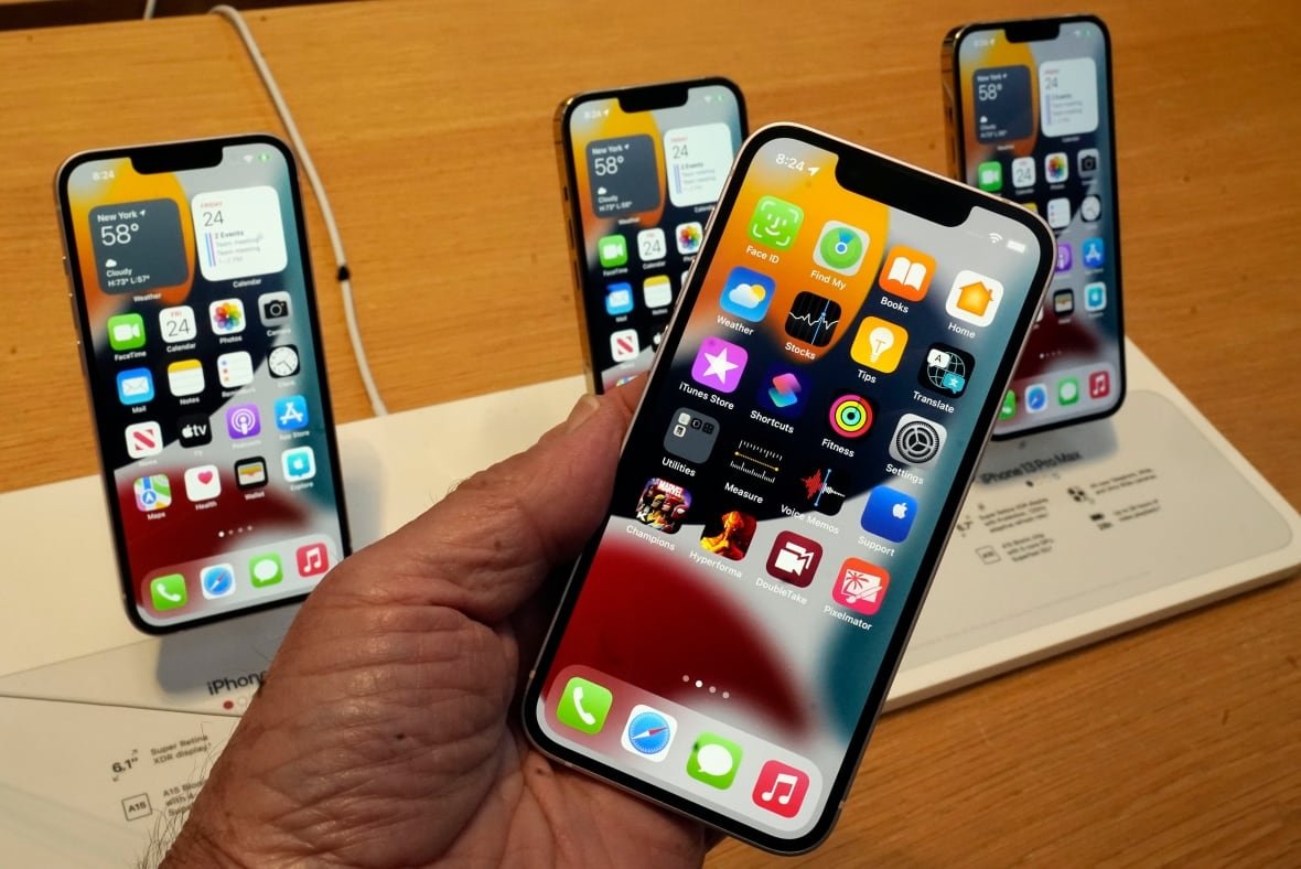 A hand holds an iPhone.