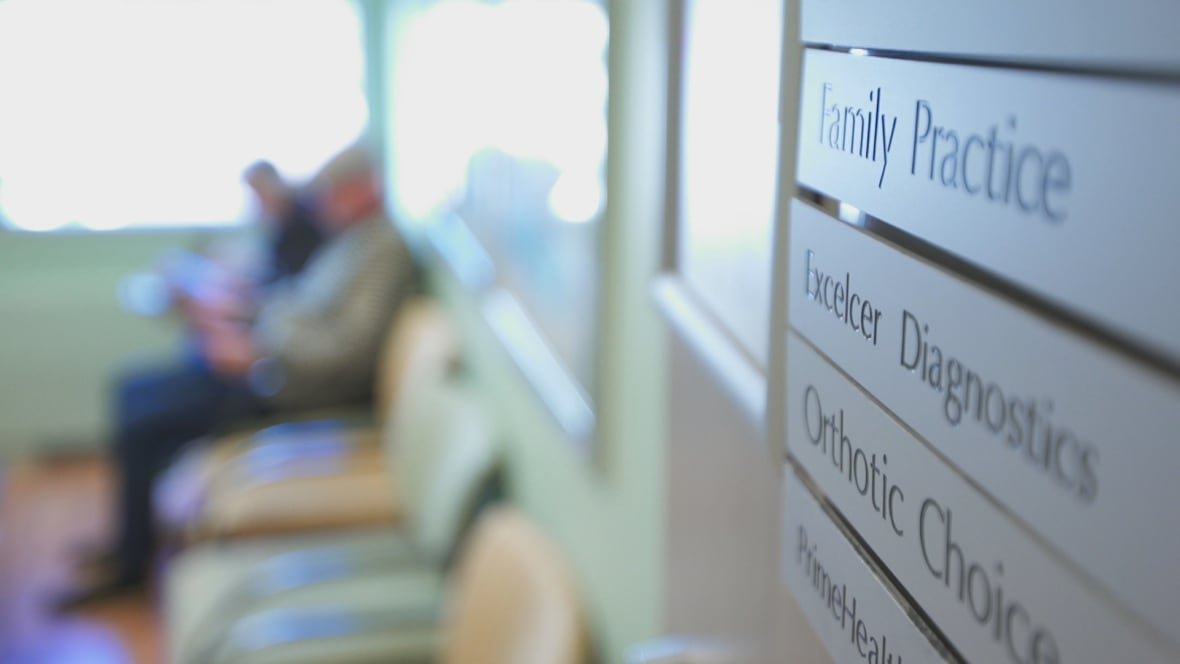 People sit in the waiting room of a doctor's office.