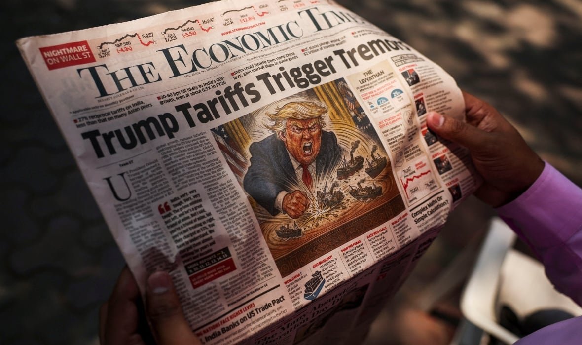 The front page of a newspaper says 'Trump tariffs trigger tremors'