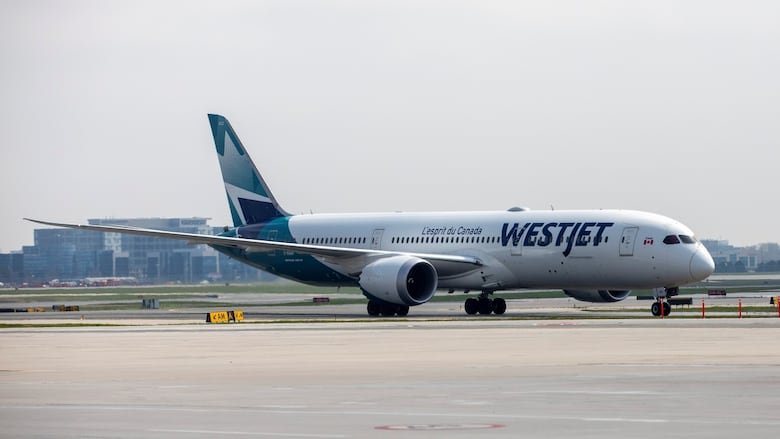 A WestJet plane is seen.
