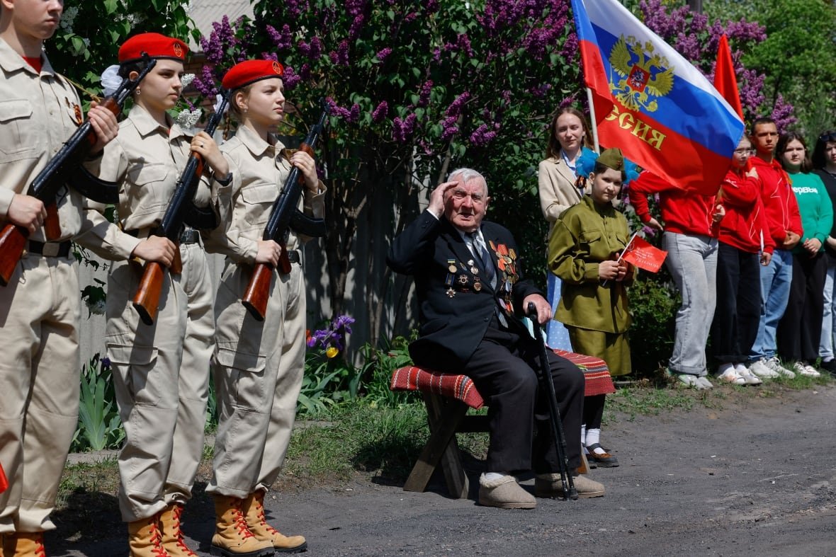 World War Two veteran Vasily Pampukhov, 102,  served with the Soviet Army after he was drafted in 1943. He watches a parade marking the 80th anniversary of the victory over Nazi Germany, in Pelahiivka  in the Donetsk region, a Russian-controlled area of Ukraine, May 7, 2025.
