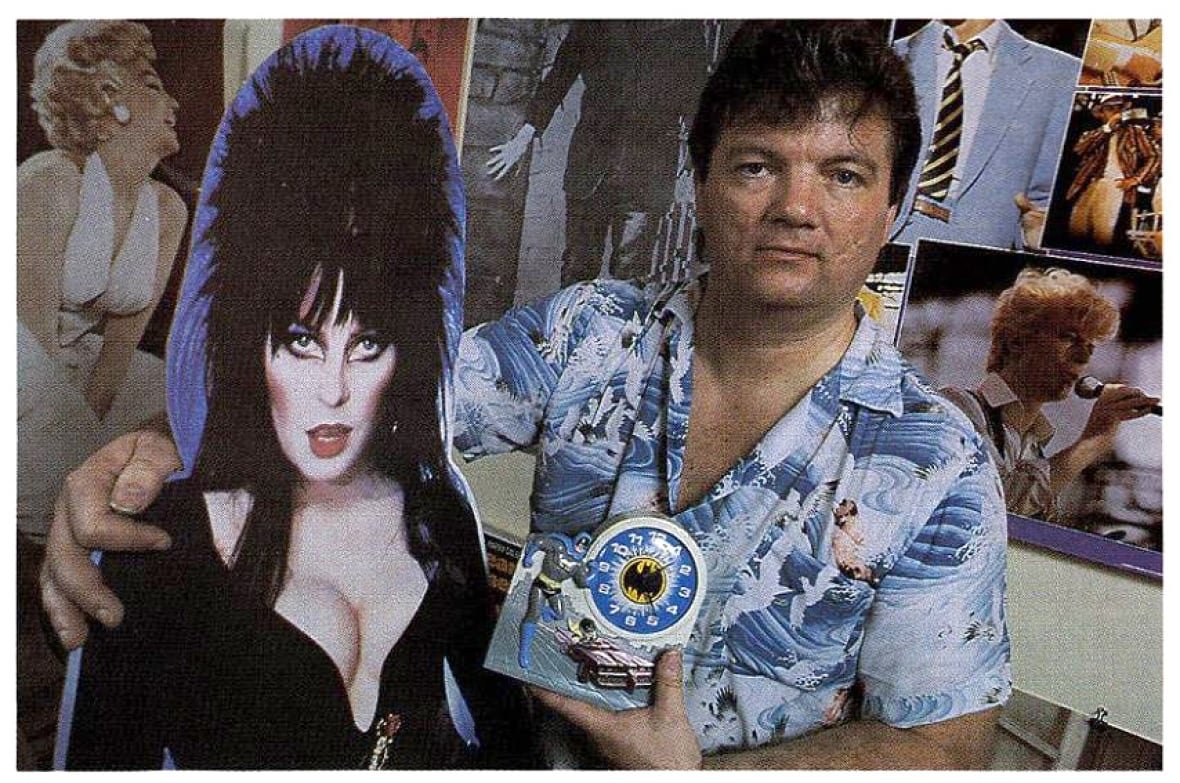 Larry "Legs" Smith poses with a cardboard cutout in his store The Attic