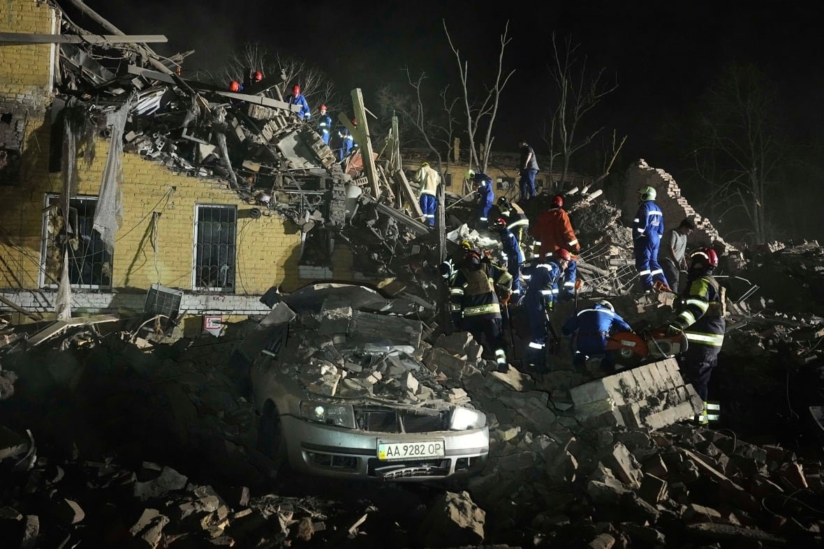 Rescuer works amid the rubble of a collapsed building.