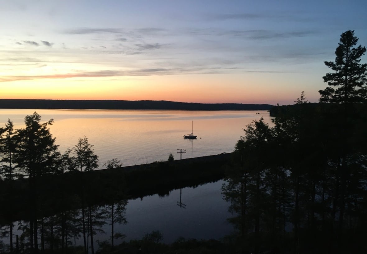 A photo shows a sunset overlooking a lake.
