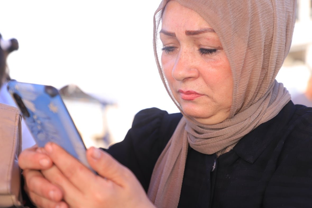 a woman looks at her cellphone
