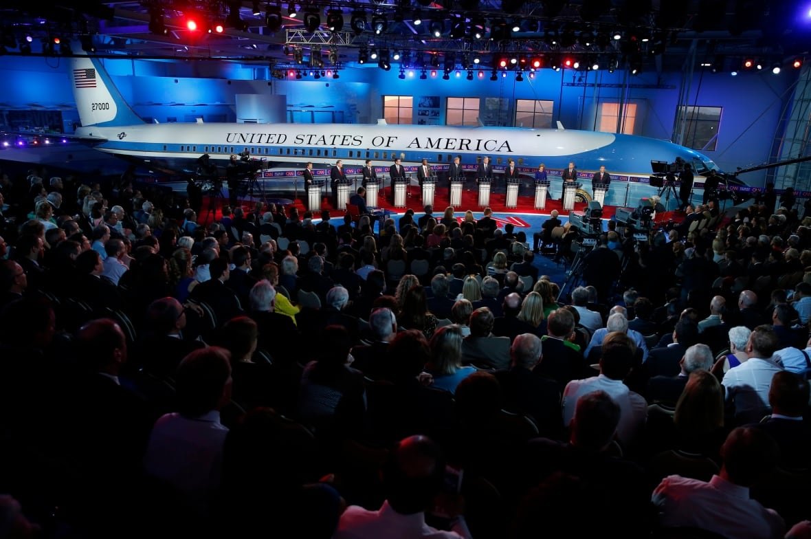 Plane in museum while people debate in the foreground